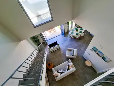 an overhead view of a living room with a table at FLH Vilamoura Duplex with Terrace & Pool in Vilamoura