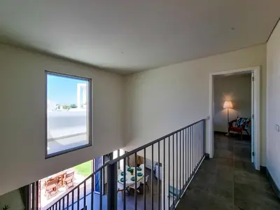 a staircase in a house with a window at FLH Vilamoura Duplex with Terrace & Pool in Vilamoura