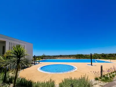 a large swimming pool sitting next to a building at FLH Vilamoura Duplex with Terrace & Pool in Vilamoura