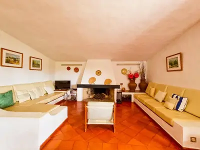 a living room with a couch and a fireplace at FLH Balaia House with Terrace in Albufeira