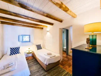 a room with a bed and a couch and a table at FLH Vale Judeu Rustic Mezzanine Cottage I in Loulé