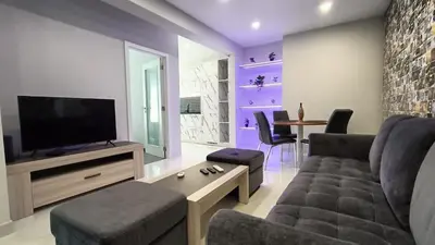 a living room with a couch and a tv at New Appartment! Albufeira in Albufeira
