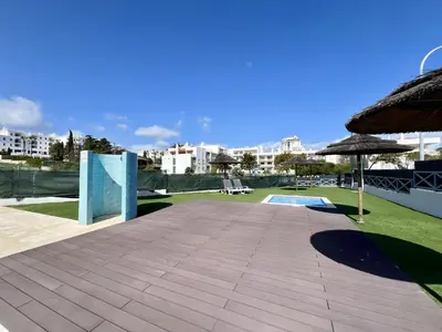 a patio with an umbrella and a swimming pool at Albufeira Modern 2 With Pool by Homing in Albufeira
