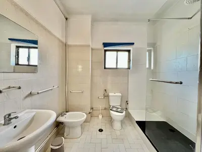 a bathroom with a toilet and a sink and a tub at Albufeira Classic 2 by Homing in Albufeira