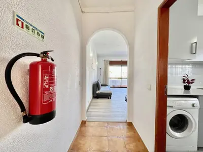 a fire hydrant is hanging on a wall in a hallway at Albufeira Classic 2 by Homing in Albufeira