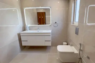 a bathroom with a sink and a toilet and a mirror at Villa Dantas by amcf in Vilamoura