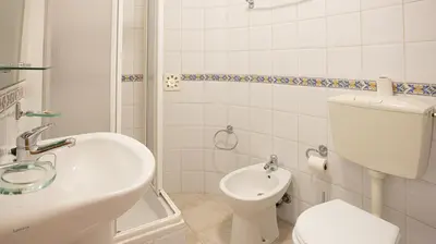 a white bathroom with a toilet and a sink at Apart Quinta dos Martins - swimming pool - BY BEDZY in Albufeira