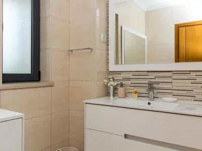 a bathroom with a sink and a mirror at Magnólia O House by Stay ici Algarve Holiday Rental in Albufeira
