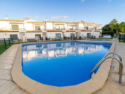 a large swimming pool in front of a house at Magnólia O House by Stay ici Algarve Holiday Rental in Albufeira