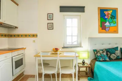 a small kitchen with a table in a room at Apartamento Studio Anastacio in Albufeira