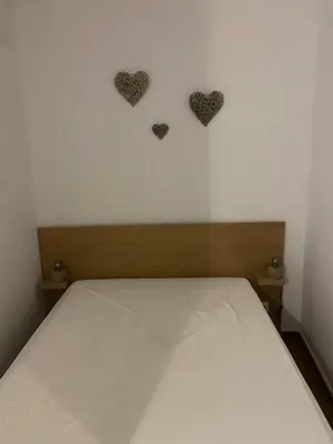 a bed with two hearts on the wall at Parra Home Holidays - Close to Galé Beach in Guia