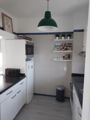 a kitchen with a white refrigerator and a green light at Quinta do Lago Golf, Sea & Sun in Quinta do Lago