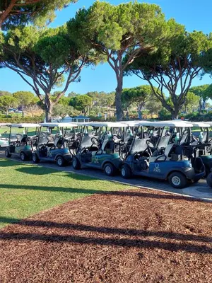 a row of golf carts parked in a parking lot at Quinta do Lago Golf, Sea & Sun in Quinta do Lago
