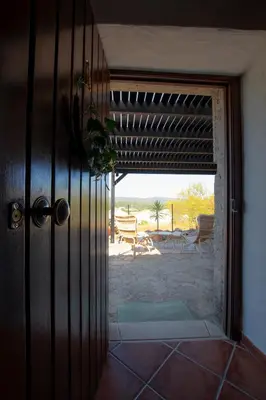 a door to a room with a view of a patio at Cosy Farmhouse Quinta da Eira 140 years old in Loulé