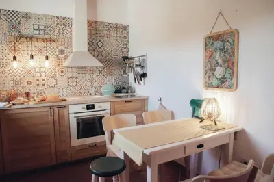 a kitchen with a table and some chairs in it at Cosy Farmhouse Quinta da Eira 140 years old in Loulé