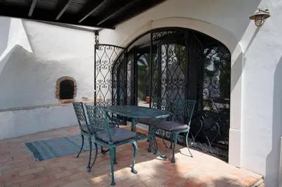 a table and chairs sitting on a patio at Suite Swimming Pool Quinta da Eira 140 years old in Loulé