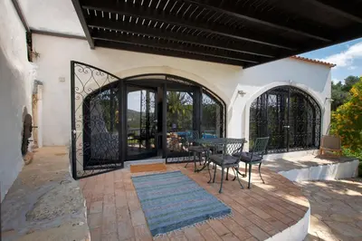a house with a patio with a table and chairs at Suite Swimming Pool Quinta da Eira 140 years old in Loulé
