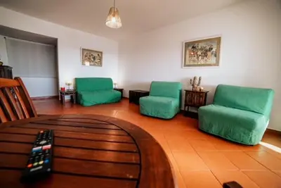 a living room with two green chairs and a couch at One Bedroom Apartment Marina View in Albufeira