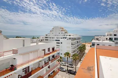 a view of the ocean from the balcony of a building at Pérola do Atlântico By the Sea in Quarteira