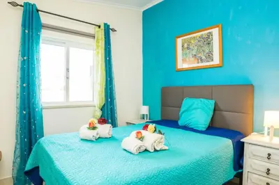 a blue bedroom with two stuffed animals on a bed at T1 Anastacio in Albufeira