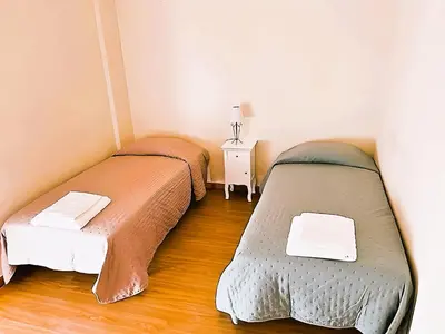 two beds in a small room with a table at Flat 3 Bedrooms Albufeira in Albufeira