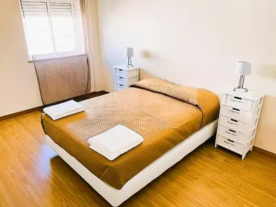 a bedroom with a bed and two night stands at Flat 3 Bedrooms Albufeira in Albufeira