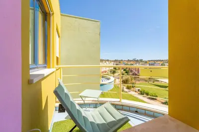 a balcony with a chair and a table and a view at Lovely LM Penthouse in Albufeira