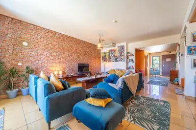 a living room with blue couches and a brick wall at Lovely LM Penthouse in Albufeira