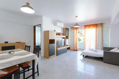a kitchen with a table and a dining room with a tableablish at T1 Apartment Albufeira Old Town - Center in Albufeira