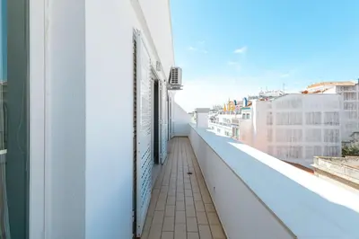 a white table and chairs in a room with a window at T1 Apartment Albufeira Old Town - Center in Albufeira
