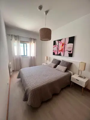 a bedroom with a large bed in a white room at Joyful Marina - Albufeira in Albufeira