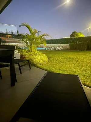 a park with a bench and a field of grass at Albufeira Malpique Beach Apartment in Albufeira