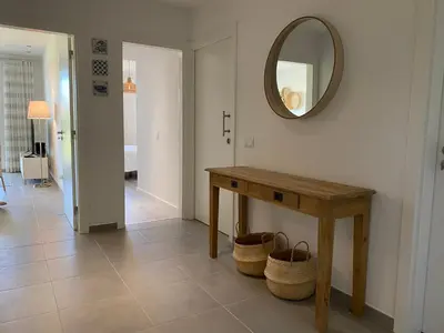 a room with a table and a mirror on the wall at Albufeira Malpique Beach Apartment in Albufeira