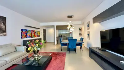 a living room with a couch and a table at Cavalo Branco Portugal in Quarteira