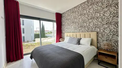 a bedroom with a bed and a large window at Cavalo Branco Portugal in Quarteira