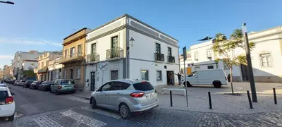 a city street with cars parked on the street at Casa da Travessa - casa de férias no coração de Faro in Faro