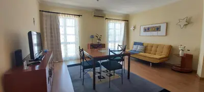a living room with a table and a couch at Casa da Travessa - casa de férias no coração de Faro in Faro