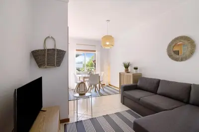 a living room with a couch and a table at Ae Flat Falesia in Albufeira