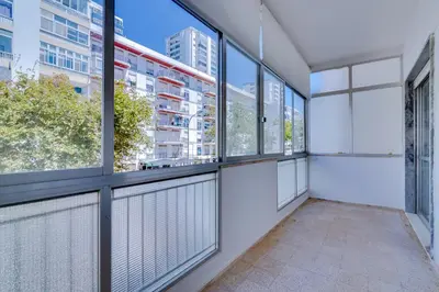 an empty room with windows in a building at AL - Oceano T2 Frente Mar Quarteira in Quarteira