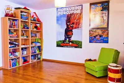 a room with a book shelf and a movie poster at Coloured Studio in Faro