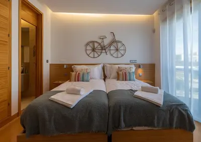 a bedroom with a bed with a bike on the wall at Algarve Vale Lobo Golf&Beach with Private Pool I in Vale do Lobo