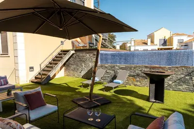 a patio with an umbrella and chairs and a table at Algarve Vale Lobo Golf&Beach with Private Pool I in Vale do Lobo