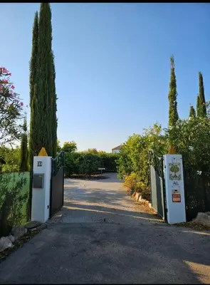 a gate to a driveway with trees and trees at Casa Aventura in Boliqueime