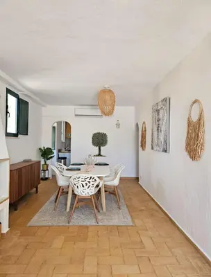 a dining room with a table and chairs at Casa Aventura in Boliqueime
