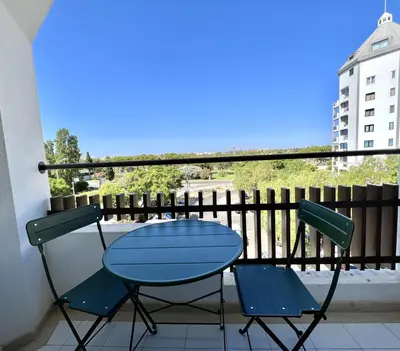 a blue table and two chairs on a balcony at Porto Marina - City center by HD PROPERTIES in Vilamoura