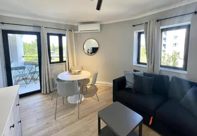 a living room with a couch and a table at Porto Marina - City center by HD PROPERTIES in Vilamoura