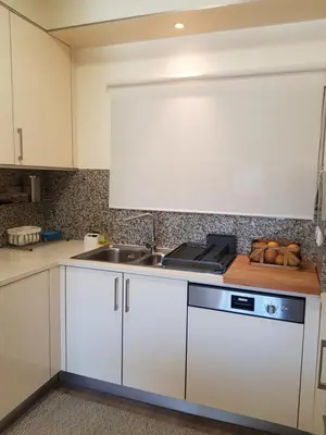a kitchen with white cabinets and a sink at MARINA DE ALBUFEIRA, Best Apartment in Albufeira