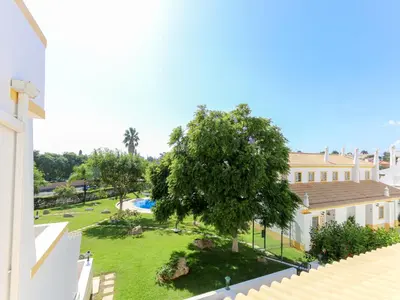 a view of the garden from the balcony of a house at Cozy Townhouse Vila Rafaella2 near São Rafael Beach Albufeira in Albufeira
