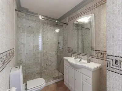 a bathroom with a shower and a toilet and a sink at Cozy Townhouse Vila Rafaella2 near São Rafael Beach Albufeira in Albufeira