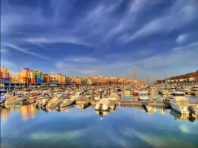 a group of boats docked in a marina with buildings at Cozy Townhouse Vila Rafaella2 near São Rafael Beach Albufeira in Albufeira